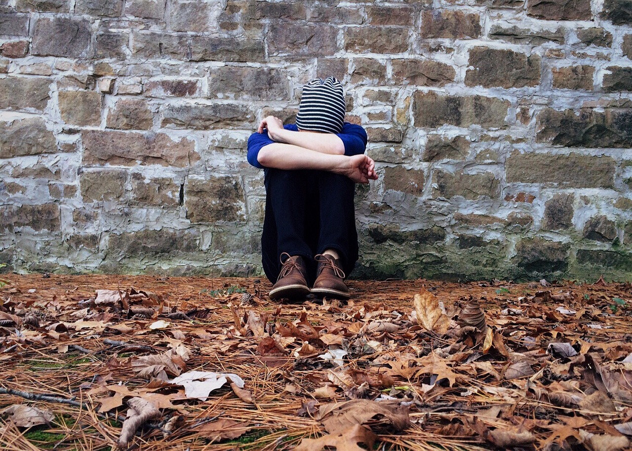 Person sitting alone looking sad