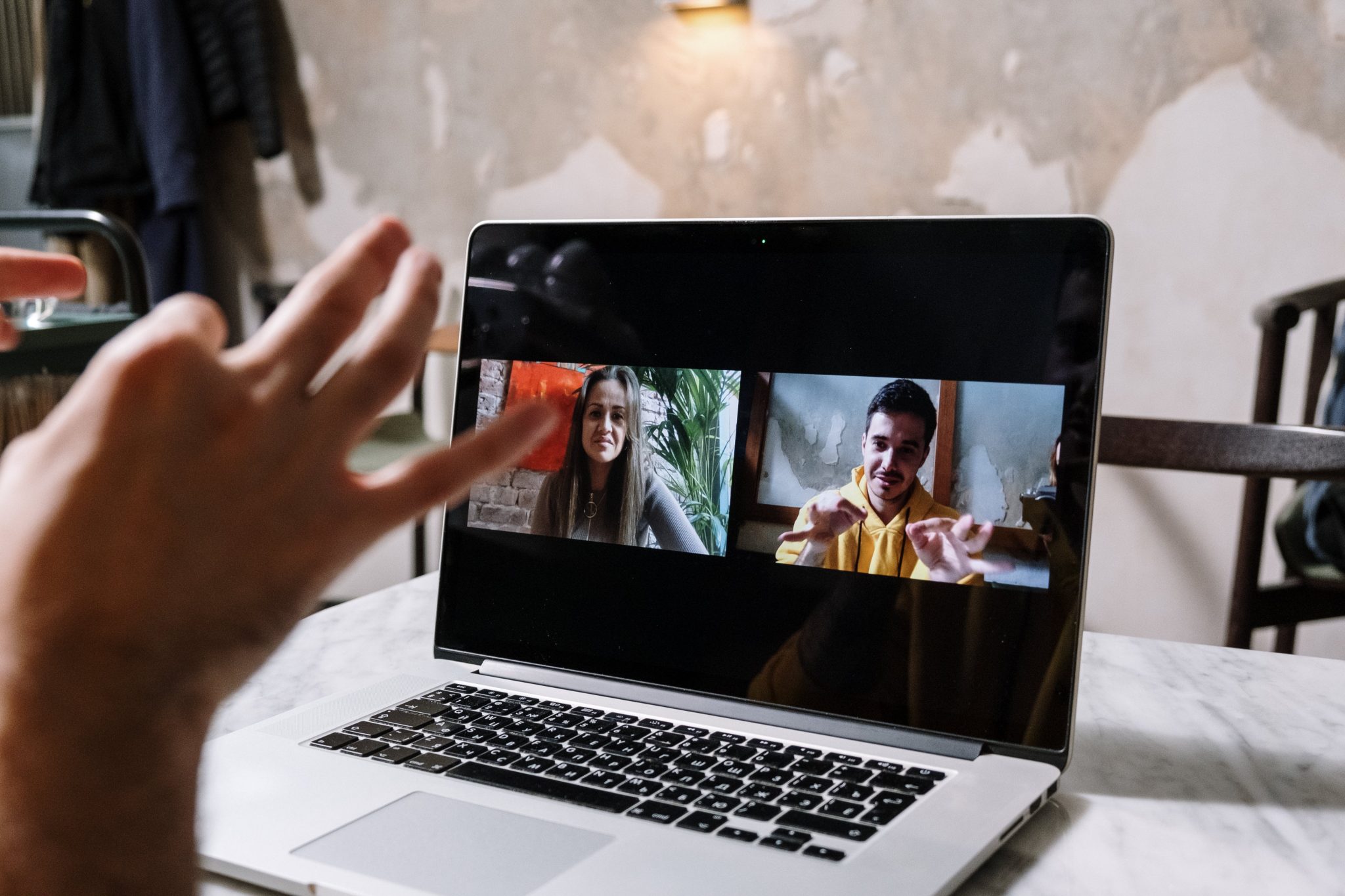 Online meeting taking place between three people